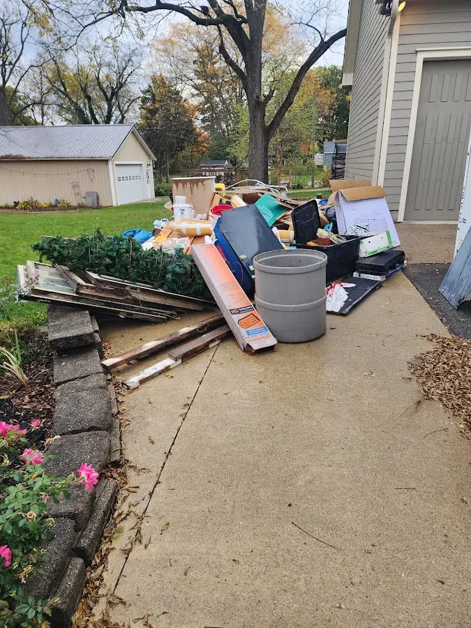 Dumpster being loaded with debris for Roofing Dumpster Rental in Marshall